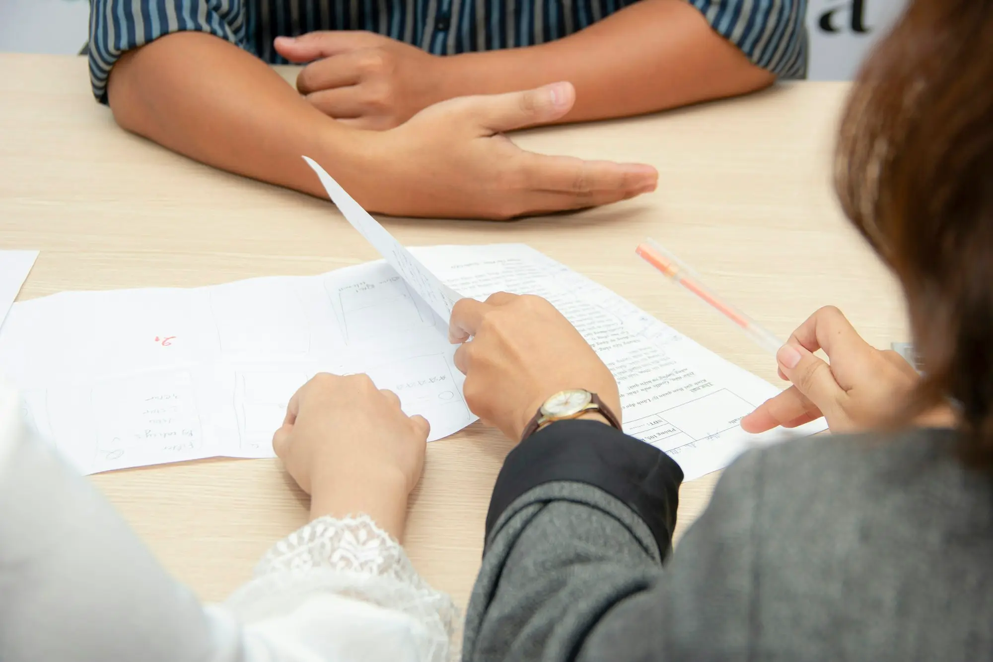 Business owner and accountant reviewing documents at a meeting table